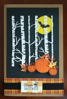 a handmade halloween card with pumpkins and bats