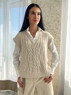 Sweater vest is knitted from gentle alpaca blend yarn, so cozy and warm. Beautiful cable knit vest is a perfect wardrobe item to be stylish. Womens handmade sweater vest gives you warm. SIZE: S/M Width: 56 cm. Length: 58 cm. L/XL Width: 64 cm. Length: 60cm. Composition: 65% alpaca, 28% pa, 7% wool. Color: Light beige melange. 100% handmade. Cozy Knit Sleeveless Sweater Vest, Winter V-neck Chunky Knit Sweater Vest, Cozy Cable Knit Sleeveless Sweater Vest, Chic Cable Knit V-neck Sweater Vest, Cozy Sleeveless Cable Knit Sweater Vest, Cozy Chunky Knit Sleeveless Sweater Vest, Cozy Cable Knit Sweater Vest, Beige Cable Knit Sweater Vest, Winter Chunky Knit Sleeveless Vest