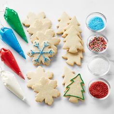 christmas cookies decorated with icing and sprinkles on a white counter top