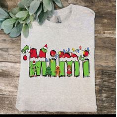 a white t - shirt with the word grino on it and christmas decorations in green