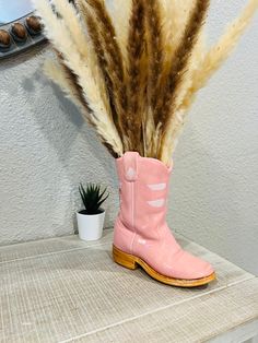 7" Handpainted Ceramic Cowboy Boot Vase, Boho Decor, Neutral Decor, Boho Cowgirl Gift, Planter, Bud Vase, Cowgirl Vase for Flowers, Farmhouse Gift, Pink Cowboy Boot, Boho Decor, Southwestern, Pampas Grass This boot has its own unique touch and can not be duplicated. You will not find these anywhere and each one is 100% Hand Painted and Fired by us. PLEASE NOTE THE BOOT MUST BE WEIGHTED INSIDE TO KEEP FROM TIPPING Approx. Measurement - 8" tall x 7" long x 2.75" depth This ceramic boot has been fi Cowboy Boot Decor, Cowboy Boot Vase, Pink Cowboy Boot, Preppy Cowgirl, Boot Vase, Western Bedrooms, Pink Cowboy Boots, Western Bedroom, Pink Cowboy