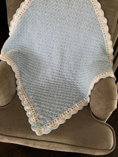 a crocheted blanket sitting on top of a chair