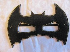 a black mask with a bat symbol on it