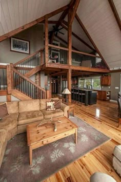 a living room filled with furniture next to a wooden floor covered in lots of wood