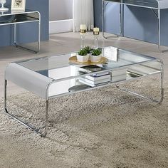 a glass coffee table sitting on top of a rug