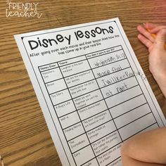 a person sitting at a table with a disney lesson on top of it and pencils in front of them