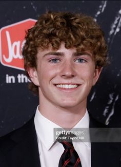 a young man wearing a suit and tie