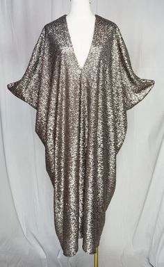 Be the life of the party in this Gunmetal Nouveau Sequin Caftan! With matte light gold, silver and bronze sequins, this luxurious and glamorous caftan will make you shine. Cozy up in the bamboo jersey lining while looking oh-so-fabulous. A perfect mix of comfort and style, this caftan is a must-have addition to your Jennafer Grace collection. Summer Party Kaftan With Sequins, Silver Sequin Dress For Celebration, Gold Kaftan For Party And Festive Occasions, Summer Party Sequined Kaftan, Glamorous Embellished Evening Kaftan, Long Sequined Kaftan For Party, Sequin Kaftan For Evening And Summer, Sequined Kaftan For Evening In Summer, Summer Evening Kaftan With Sequins