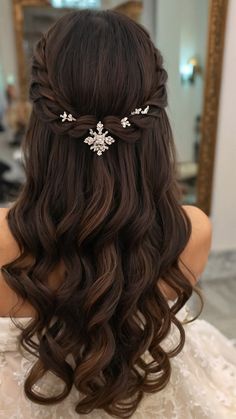 the back of a woman's head with long hair and flowers in her hair