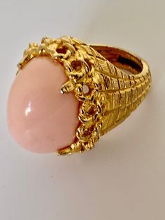 Pauline Rader Pink Cocktail Ring, Angel Skin Cabochon and Elegant Modernist Brutalist Golden Setting size 8 Awesome rare vintage glamour jewelry Art Deco revival statement ring 1970s or 80s In excellent collected vintage condition Arrives polished & gifted nicely 🎀 www.MySoulRepair.com an Etsy shoppe 🌿 www.MySoulRepair.NYC glamour jewelry & gifts Curated by marta michaud 🌸 Pink Cocktail Ring, Art Deco Revival, Glamour Jewelry, Angel Skin, Pink Cocktails, Pink Cocktail, Personalized Gift Tags, Vintage Glamour, Art Deco Jewelry