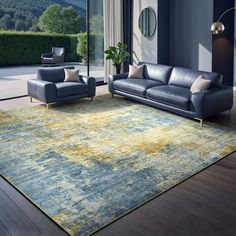 a living room with blue couches and yellow rug in front of large glass windows