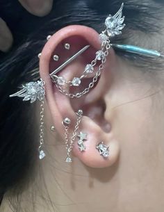 a close up of a person with piercings on their ears and behind the ear