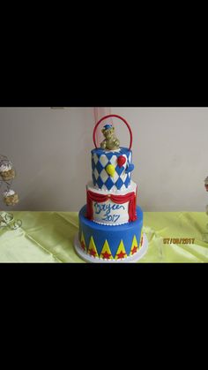 a three tiered cake decorated with circus animals