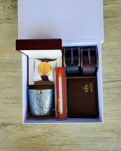 an open box containing watches and other items