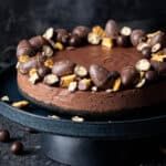 a cake with chocolate frosting and nuts on top