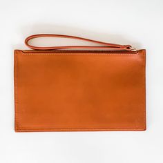 Chic and minimalist, the Slim Zip Wallet fits all the essentials for your "on the go" lifestyle. Crafted in smooth, buttery soft and sweet smelling leather. This wallet works great tossed inside a Findlay Tote or Crossbody, but also great to carry on its own for a night out on the town. Interior includes 1 large cash pocket and 4 card pockets that can fit 1-2 cards each. Also fits most mobile phones. - Smooth Full Grain 100% traceable Italian Vegetable-Tanned leather - Color - Bourbon Brown - 1 Modern Wallet With Zipper Pouch For Everyday Use, Minimalist Travel Wallet With Zipper Pouch, Leather Wallet With Flat Pocket, Classic Everyday Coin Purse With Smooth Grain, Modern Rectangular Wallets With Smooth Grain, Classic Clutch With Zipper Pouch For Everyday, Minimalist Wallets With Zipper Pouch For Daily Use, Modern Leather Wallet With Zipper Pouch, Minimalist Wallet With Zipper Pouch For Daily Use