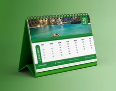 a green and white desk calendar sitting on top of a table