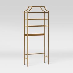 a gold metal and wood shelf with shelves