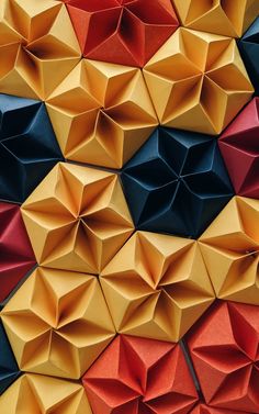 colorful origami pieces are arranged in the shape of pyramids