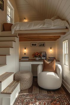 there is a loft bed above the couch in this small room with stairs leading up to it