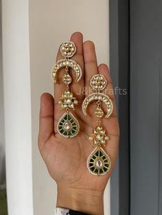 Indulge in the opulent beauty of our exquisite Kundan Dangler Earring, featuring floral stud blooms with the vibrancy of life. Descending from this floral masterpiece, a crescent-shaped Kundan unit gracefully extends, evoking the celestial allure of a moonlit night. Attached to this crescent unit is a whimsical fish-shaped Kundan element, completing this enchanting composition is a verdant green teardrop Kundan unit, suspended delicately at the bottom of the earring. Adding a touch of natural splendor completes the symphony of beauty that is our Kundan Dangler Earring. Closure - Push Back. Cheap Green Earrings With Latkans, Luxury Green Bollywood Jhumkas, Luxury Kundan Jhumkas For Festive Season, Elegant Handmade Bridal Earrings For Diwali, Elegant Hand Set Chandbalis For Ceremonies, Elegant Hand Set Chandbalis For Ceremonial Occasions, Elegant Hand-set Chandbalis For Ceremonial Occasions, Elegant Ceremonial Chandbalis, Elegant Handmade Kundan Bridal Earrings