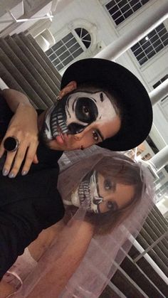 a man and woman dressed up in skeleton makeup