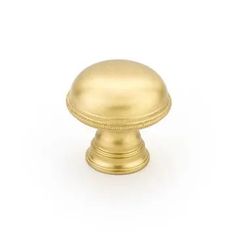 an antique brass knob on a white background