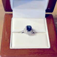 an engagement ring in a wooden box