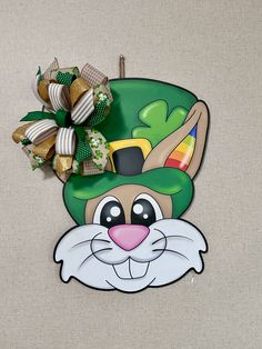 a st patrick's day decoration with a green hat and shamrocks on it