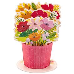 a pink vase filled with lots of colorful flowers