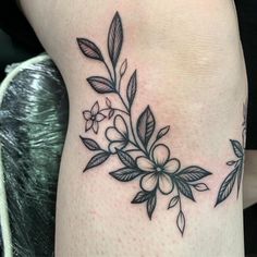 a black and white flower tattoo on the leg