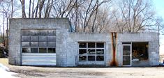 an old run down garage with broken windows