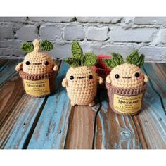 three crocheted pots with plants in them