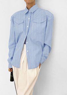 Color: White Stripe Crisp woven shirting fabric Relaxed fit Padded shoulders Pointed collar Flap breast pockets Button cuffs Curved hem Button front closure 80% Polyester 20% Cotton Imported Product Measurements: S- 20" Shoulder, 44" Bust, 26" Length M- 20.5" Shoulder, 46" Bust, 26.5" Length L- 21" Shoulder, 48" Bust, 27" Length Model is 174cm/ 5'8" wearing size S Spring Tops With Striped Fold Down Collar, Collared Shirt With Buttoned Pockets For Daywear, Collar Blouse With Pockets For Daywear, Business Casual Blouse With Spread Collar And Pockets, Office Shirt With Pockets And Lapel Collar, Business Casual Blouse With Pockets And Spread Collar, Collared Tops With Buttoned Pockets For Business Casual, Collared Tops With Pockets For Office, Classic Collared Blouse With Buttoned Pockets