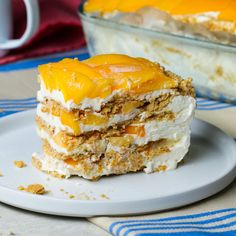 a piece of cake sitting on top of a white plate next to a glass dish