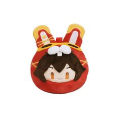 a red and yellow stuffed animal with ears on it's head, wearing a crown