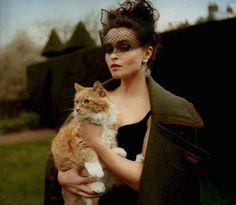 a woman holding a cat in her arms