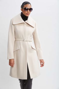 Wrap up this season in our chic belted coat done in a warm double face wool. This sophisticated fully lined coat makes a cold weather statement featuring an oversized collar, contour seams and vegan leather belt; the silhouette is a modern twist on a classic, setting a new standard in outerwear. Elie Tahari Exclusive Panel Wool Coat with Vegan Leather Belt & oversized collar 80% Wool, 15% Nylon, 5% Cashmere Runs true to Size Length From Shoulder to Hem: Back 38.5"L, Sleeve: 33"L (approx. length Elegant Belted Beige Pea Coat, Elegant Beige Belted Pea Coat, Elegant Wool Coat With Belted Cuffs And Lapel Collar, Chic Pea Coat With Belted Cuffs For Formal Occasions, Chic Formal Pea Coat With Belted Cuffs, Chic Wool Coat With Concealed Front Fastening, Chic Wool Coat With Belted Cuffs And Lapel Collar, Chic Wool Coat With Belted Cuffs For Formal Occasions, Chic Wool Coat With Belted Cuffs For Office