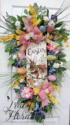 an easter wreath is hanging on the front door