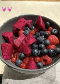 a bowl filled with blueberries, raspberries and watermelon