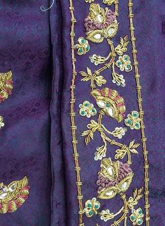 an embroidered purple jacket with gold trimmings and flowers on the front, along with two