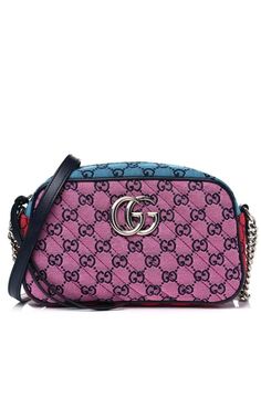 This GG Marmont small shoulder bag has an adjustable strap and is part of the GG Multicolor collection. Pink, green, red and blue diagonal matelassé GG canvas. Blue leather trim. Silver-toned hardware. Double G. Interior open pocket. Adjustable chain shoulder strap with 23.5" drop. Zipper closure with elongated zipper pullers. Cotton linen lining. Composition: Organic Cotton 100%Lining: Organic Cotton 100%Trims: Leather 100% 5.5"H x 9.5"W x 3"D.Made in Italy Luxury Multicolor Gucci Shoulder Bag, Luxury Multicolor Shoulder Bag With Zipper Closure, Luxury Multicolor Shoulder Bag With Chain Strap, Gg Marmont Small Shoulder Bag, Gucci Runway, Buy Gucci, Gg Marmont, Small Shoulder Bag, Chain Shoulder Bag