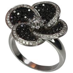 S.Georgios Floral 18 Karat White gold ring is all handmade and is decorated with Brilliant cut Diamonds shaped like flower petals. The Black diamonds are a total weight of 0,70 Carats and the white diamonds a total weight of 0.45 Carat. This gorgeous ring can be also ordered in Yellow or Rose gold. Please contact us for any adjustments. This Beautiful ring is of outstanding quality and workmanship and is made in our workshop in Athens Greece. Width: 22.0 mm Weight: 12.20 grams Size: 7 For a full Black Diamond Rings, Rose Gold Eternity Band, Contemporary Wedding Rings, Yellow Gold Cocktail Ring, Gorgeous Ring, Gold Cocktail Ring, Black Diamond Ring, Black Diamonds, Brown Diamond