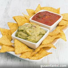 some chips and guacamole are sitting on a plate with salsa in it