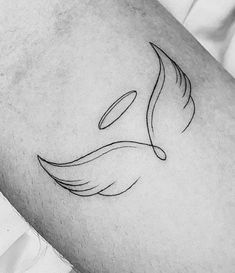 a black and white photo of a bird tattoo