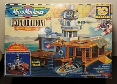 a box with an image of a boat in the water next to a lighthouse and other toys