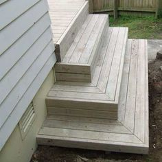 the steps are made out of wood and have been placed on the side of the house