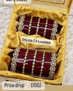 two brown bracelets in a box with price tags on the front and back side