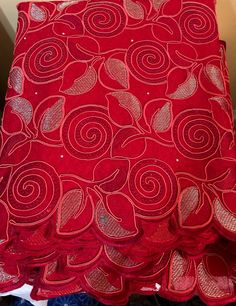 a red cloth with swirls on it