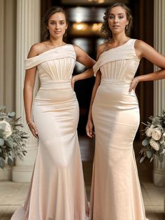 two beautiful women standing next to each other in formal wear and one is wearing a long dress